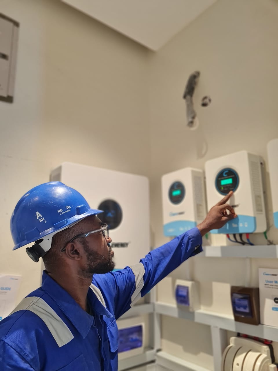 J.E Electrical technician commissioning an inverter and battery system
